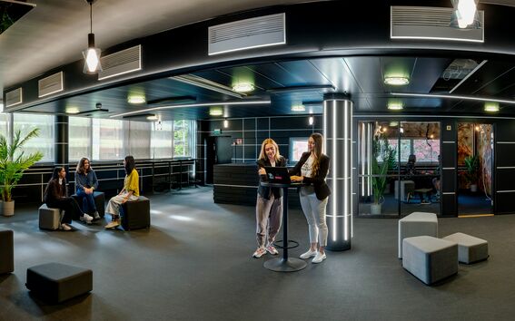 People interacting in Jedi Training School event space in startup hub A Grid